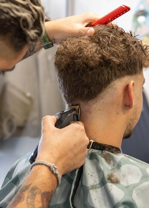 A man getting a hair fade.