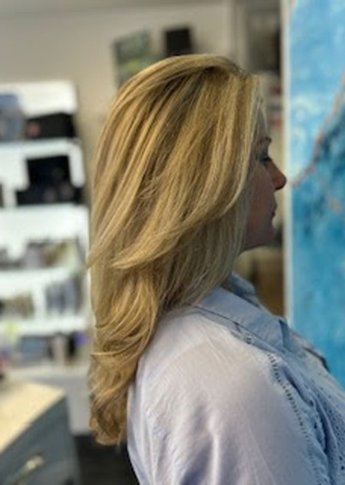 A woman with blow dried blonde hair.
