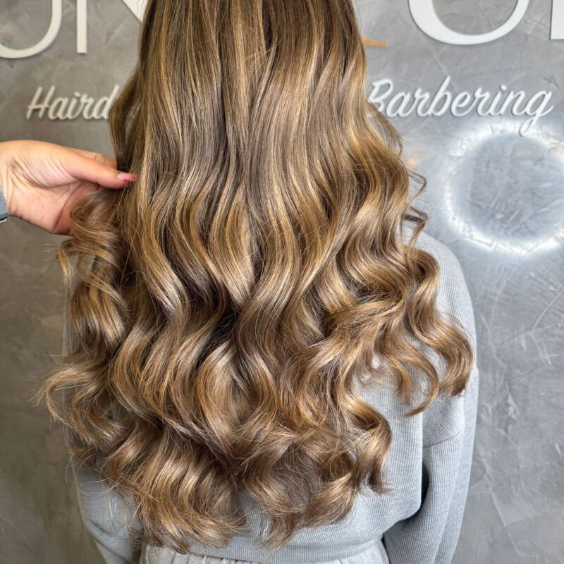 A girls blonde hair extensions from Unique Hairdressing in Bishop's Stortford.