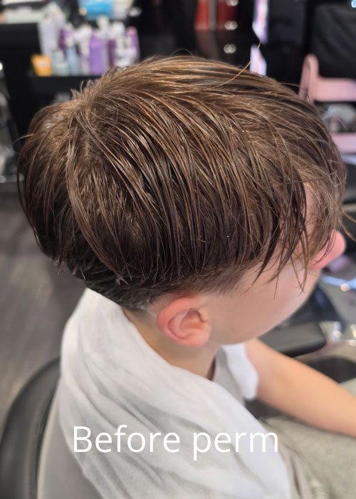 A boy's hair wet and straight.
