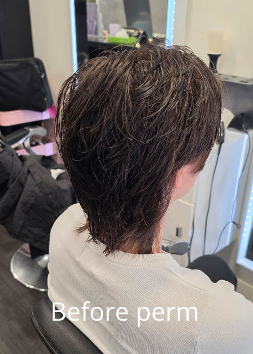 A person with short, black, straight hair.